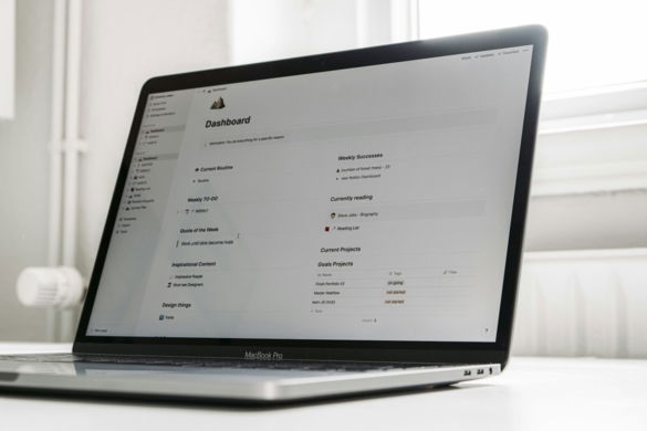 a laptop computer sitting on top of a white table